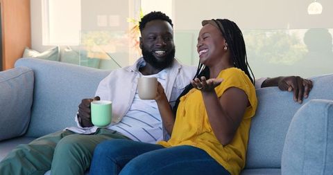 Happy Couple Relaxing at Home with Coffee Conversation