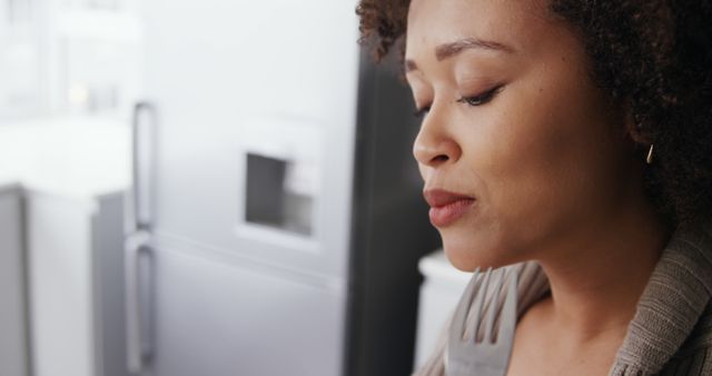 Pensive Woman Thinking Deeply in Modern Kitchen Setting - Download Free Stock Images Pikwizard.com