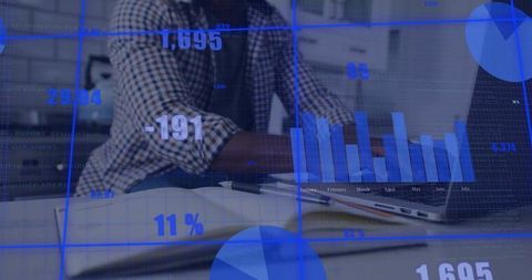 Remote professional analyzing digital dashboard across notebook and laptop in home office