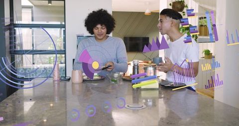 Young professionals interacting with augmented reality analytics at marble kitchen island