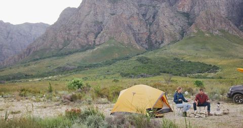 Couple Enjoying Outdoor Camping by Scenic Mountains