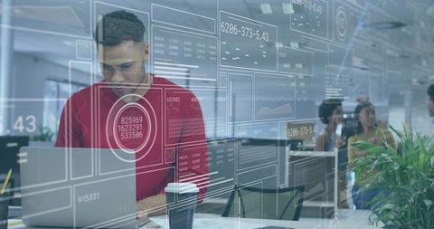 Data analyst using laptop with AR dashboards in collaborative open office