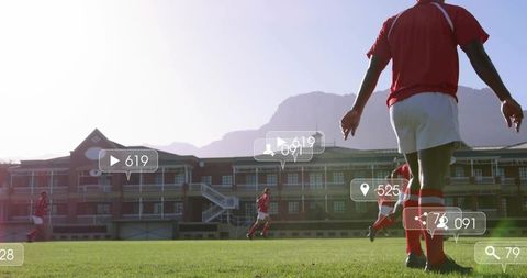 Soccer players running on sunlit pitch with social media engagement overlay and analytics