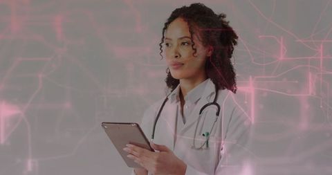 Doctor with Lap Tablet and Stethoscope Analyzing Futuristic Data