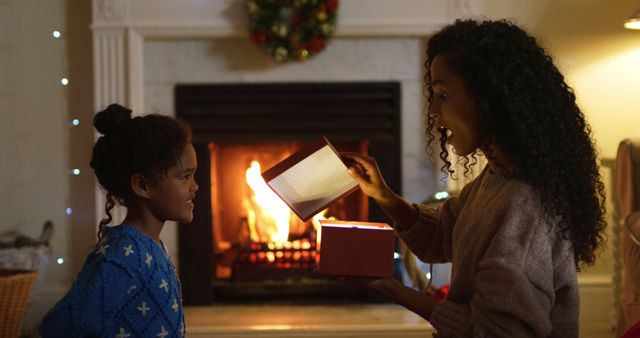 Mother Surprising Daughter with Christmas Gift in Cozy Holiday Setting - Download Free Stock Images Pikwizard.com