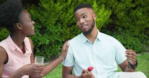 Couple Bonding Over Strawberries in Garden Setting