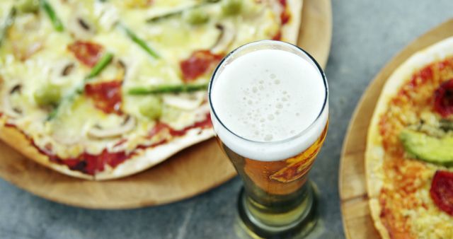 Two Delicous Pizzas and Glass of Beer on Table - Download Free Stock Images Pikwizard.com