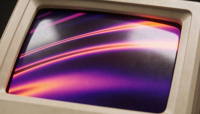 Retro beige crt monitor glass showing curved neon purple and orange light streaks
