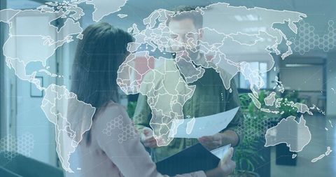 World Map Overlay on Business Colleagues in Office Environment