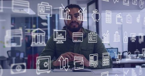 Business analyst studying financial dashboards with digital icons in modern open office