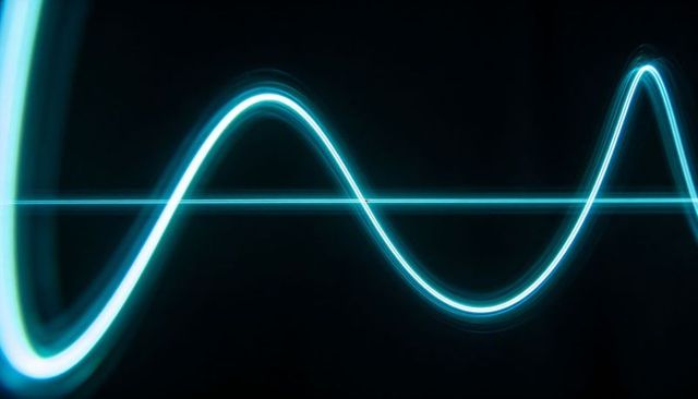 Glowing cyan sine wave signal running across dark digital studio background