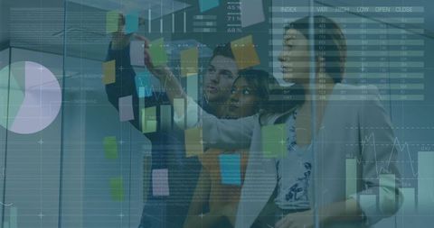 Team Collaborating with Sticky Notes and Data Visualization on Glass Wall in Modern Office