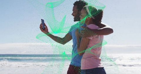 Couple taking selfie at beach with digital overlay