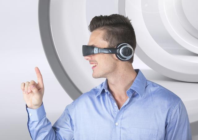 Man is enthusiastically gesturing while wearing a VR headset. Perfect for themes of technology innovation, virtual experiences, and digital entertainment. Ideal for promoting VR devices, technology advancements, and interactive media.