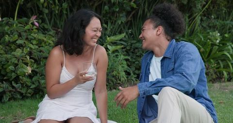 Friends Relaxing Outdoors with Drinks and Laughter