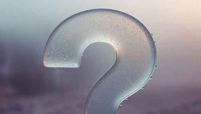 Glistening Transparent Question Mark with Water Droplets