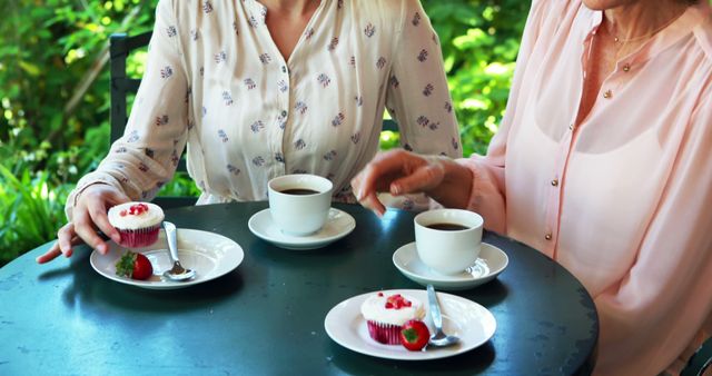 Women Enjoying Coffee and Cupcakes at Outdoor Cafe - Download Free Stock Images Pikwizard.com