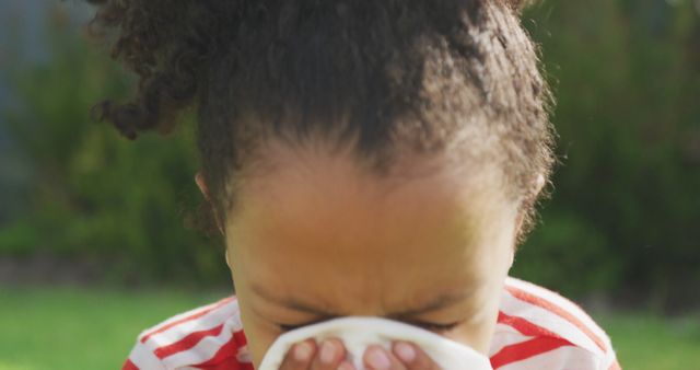 Child Sneezing into Tissue in Outdoor Park - Download Free Stock Images Pikwizard.com