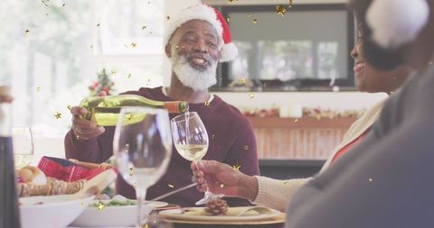 Joyful Older Couple Celebrating Christmas with Sparkling Wine