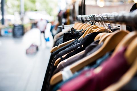 Clothes hanging on hangers in outdoor market