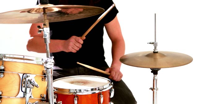Drummer playing his drum kit on white background - Download Free Stock Photos Pikwizard.com