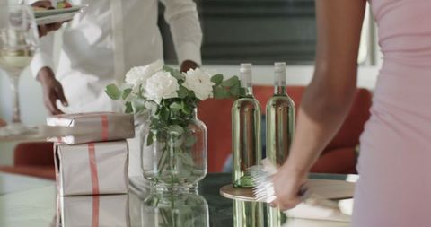 Arranging Elegant Table with Gifts and Flowers for Celebration