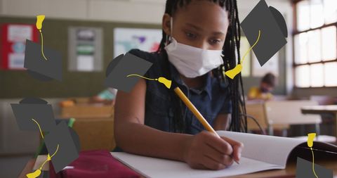 Masked student focused on schoolwork in classroom
