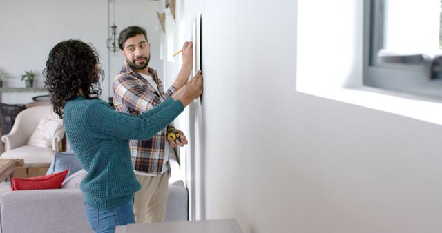 Couple Decorating Home Together Hanging Picture on Wall - Download Free Stock Images Pikwizard.com