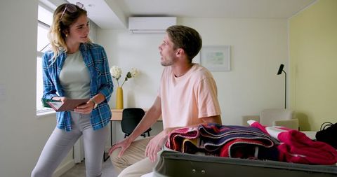 Couple Packing Suitcase Together Before an Exciting Vacation
