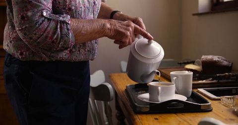 Senior Woman Preparing Coffee in Cozy Kitchen Setting - Download Free Stock Images Pikwizard.com