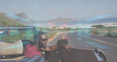 Man cruising coastal highway in convertible with sunglasses, ocean view and scenic dunes