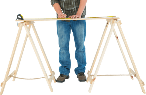 Transparent worker measuring wooden plank on sawhorses for construction