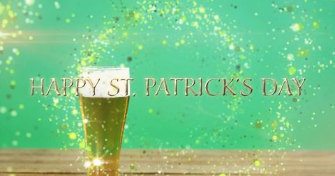 Green beer pint and gold happy st. Patrick's day text with sparkling confetti celebration