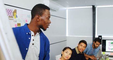 Diverse Team Engaged in Discussion in Modern Office Environment