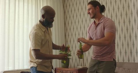 Two men relaxing with beverages in cozy home environment