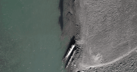 Transparent Aerial View of Calm Lakeshore with Sandy Beach