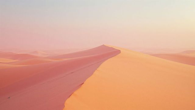 Golden sand dunes under tranquil pastel sky