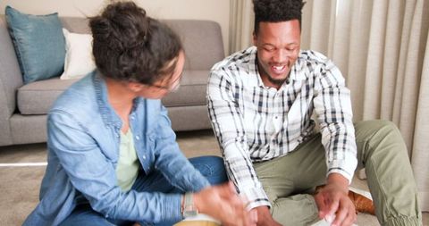 Happy Mixed-Race Couple Planning Finances on Laptop