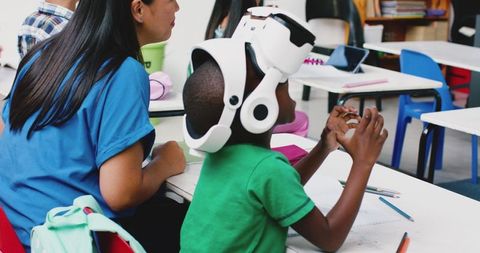 Child Experiencing Virtual Reality in Classroom with Teacher