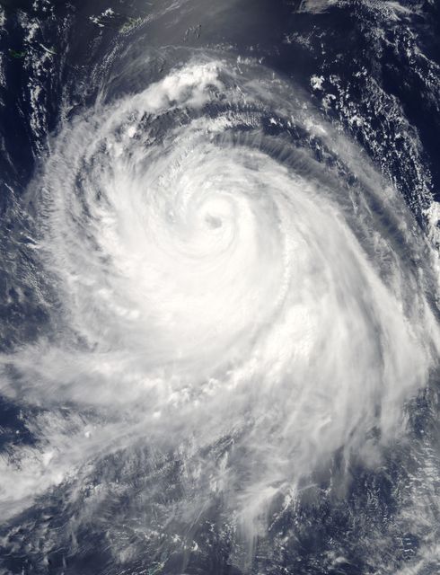 This dramatic satellite image of Typhoon Chan-Hom, taken from NASA’s Aqua satellite in July 2015, visibly showcases the eye of the storm surrounded by intense thunderstorms. With detailed cloud formations spiraling around, this image vividly illustrates the power of nature and is excellent for use in meteorology presentations, educational materials, climatology research, severe weather preparedness content, and atmospheric sciences studies.