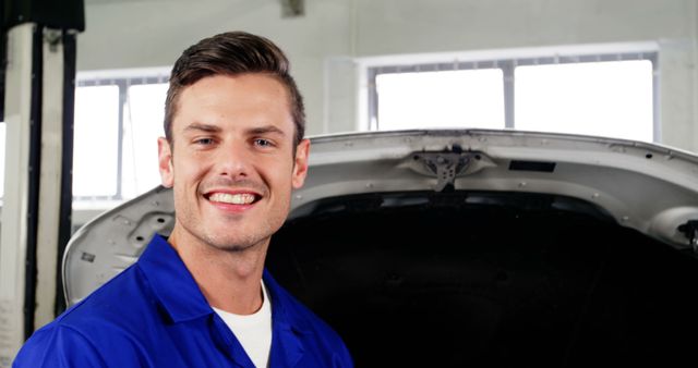 Smiling Male Mechanic Standing by Car Engine - Download Free Stock Images Pikwizard.com