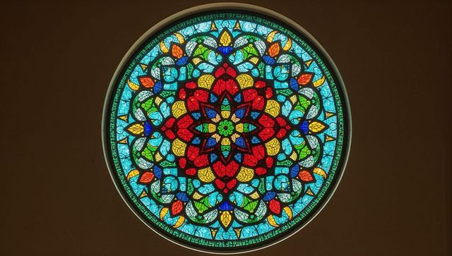 Vibrant circular stained glass window with ornate pattern