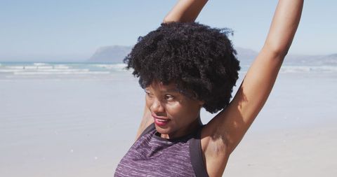 Active Woman Practicing Yoga on Sunny Beach