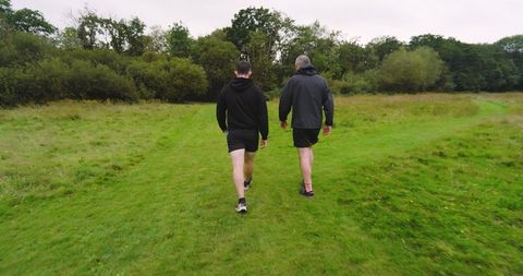 Two Men Jogging in Green Park Path Enjoying Outdoor Fitness - Download Free Stock Images Pikwizard.com