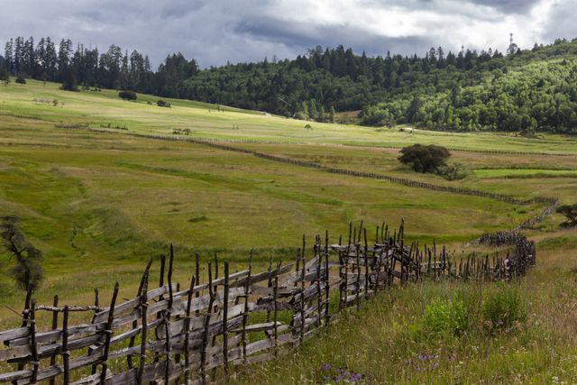 Rustic Fence in Expansive Countryside Landscape with Forested Hills - Download Free Stock Photos Pikwizard.com