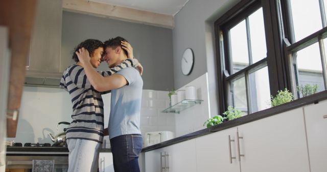 This image shows a loving couple standing in a modern kitchen, embracing with forehead touch. It is a perfect representation of intimacy, affection, and romantic morning moments at home. Suitable for promoting home appliances, relationship counseling, home décor, or lifestyle blogs.