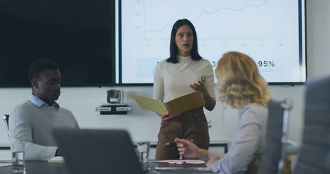 Businesswoman Leading Presentation in Modern Office Conference Room