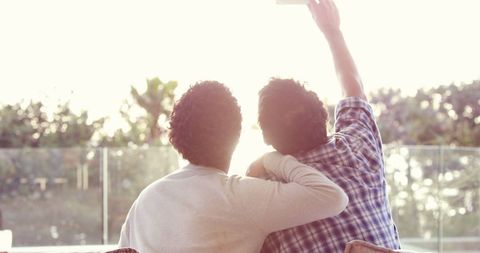 Companionship capturing memories with cheerful indoor selfie