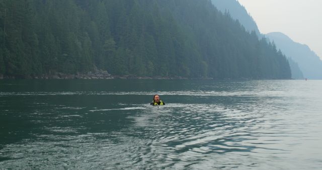 Person Swimming in Misty Mountain Lake - Download Free Stock Images Pikwizard.com