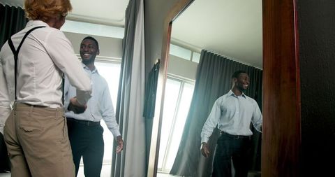 Best man and groom preparing for wedding day